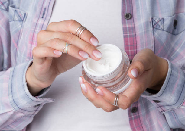 istock Woman's hands with manicure holding jar of moisturizing cream 1160733611