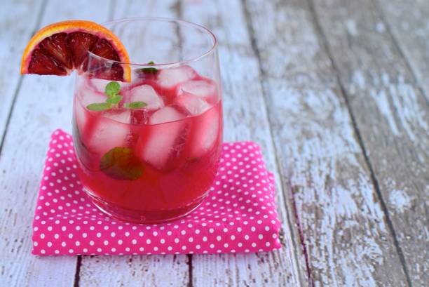 istock Blood orange cocktail drink with ice cubes and mint leaf 1160733643