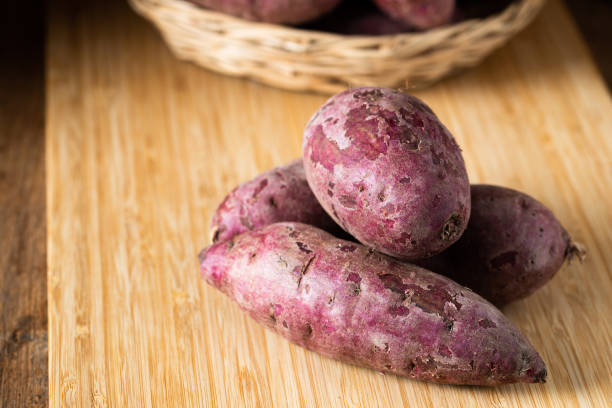 istock Sweet Potatoes Purple Colored on Table 1160733647