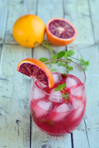 istock Blood orange cocktail drink with ice cubes and mint leaf 1160733685
