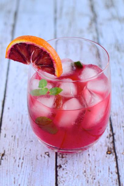 istock Blood orange cocktail drink with ice cubes and mint leaf 1160733706