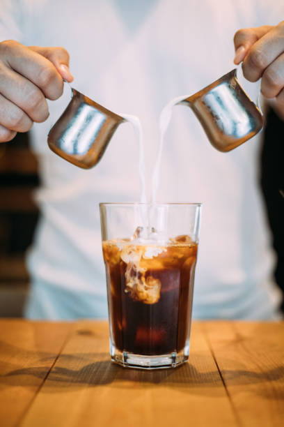 istock Pouring milk in espresso to make iced latte 1160737221