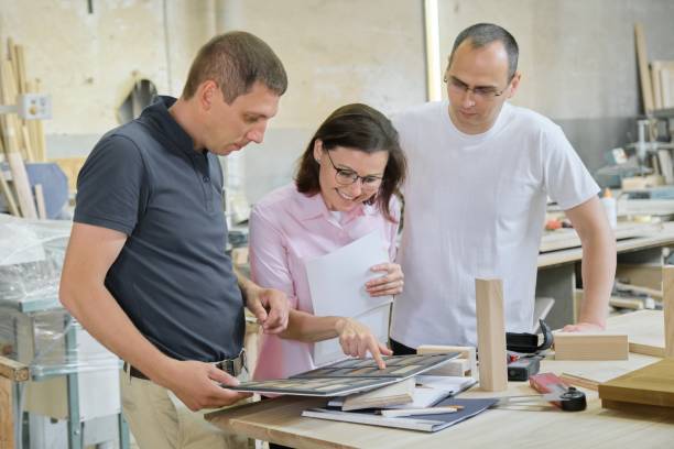 istock Group of people designer, client, carpenter, engineer choosing wooden products 1160738957