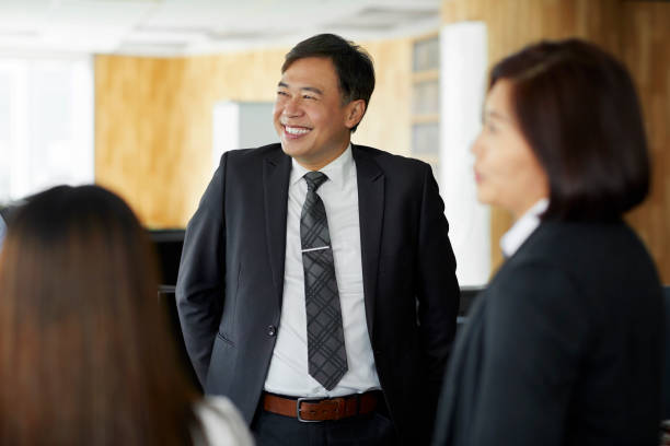istock Smiling businessman with colleagues in office 1160741921