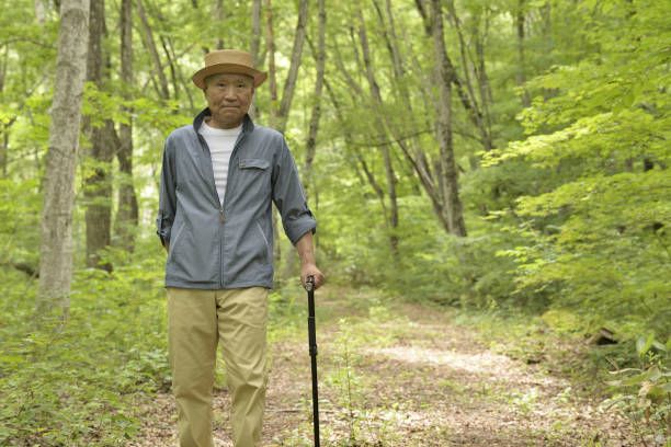 istock An old man's walk in the woods 1160742597