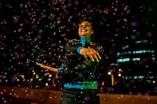 Cool woman under a rain of confetti