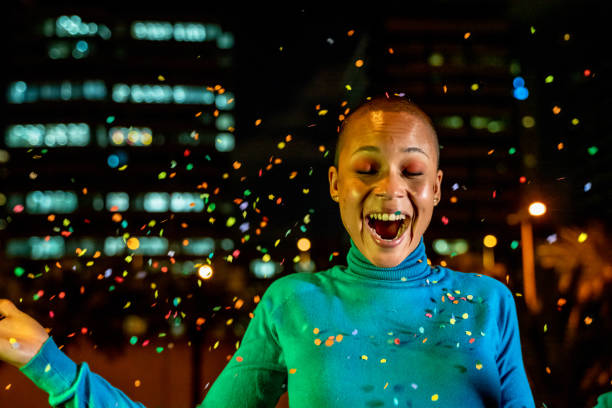 istock Cool woman under a rain of confetti 1160743225