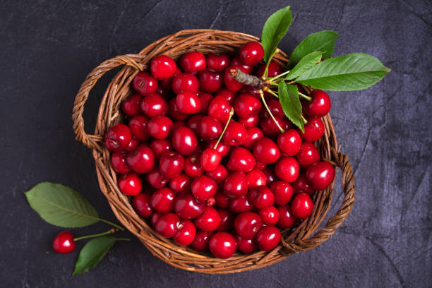 istock Fresh cherries on black background. Fresh ripe sweet cherries 1160744673