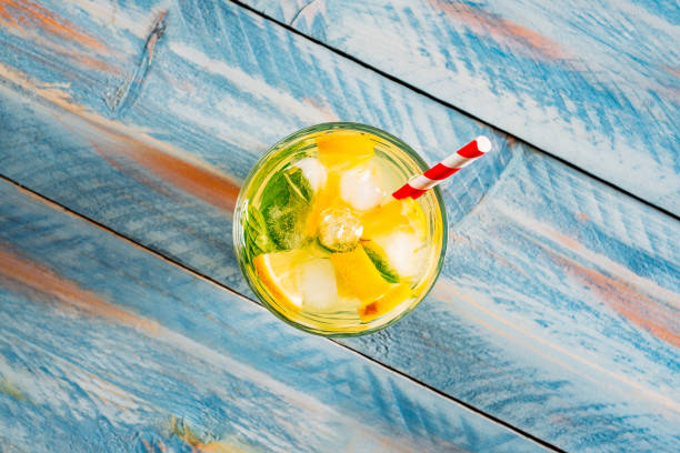 istock Fresh Lemonade on Colorful Wooden Table 1160744730