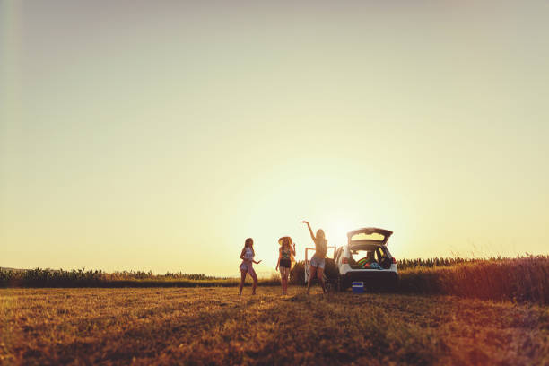 Lovely and beautiful cheerful girls taking a break while traveling to the beach.