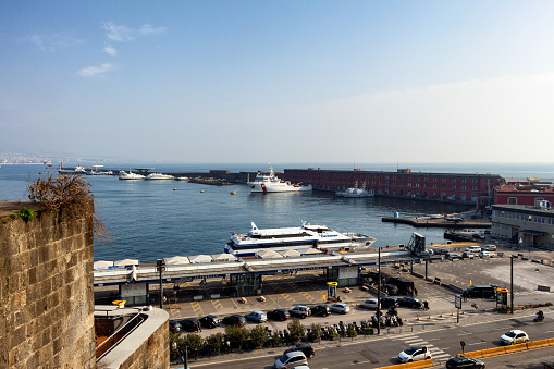 View of the port of Molo Beverello in Naples from the castle of Castel Nuovo.  The castle is a landmark, which was built by Charles I of Anjou in 1282, it also has the name - Anjou castle.