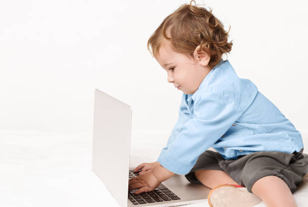 istock Cute baby boy typing on laptop keyboard 1160745624