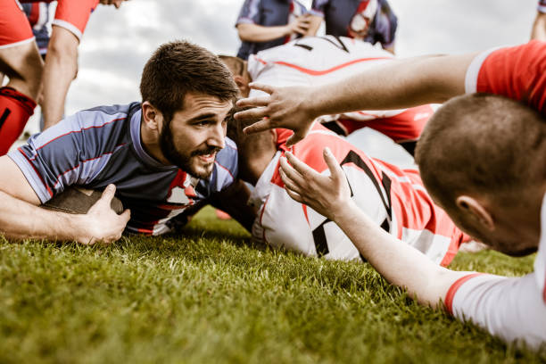 istock Rugby player scoring touchdown among his rivals on a match. 1160745995