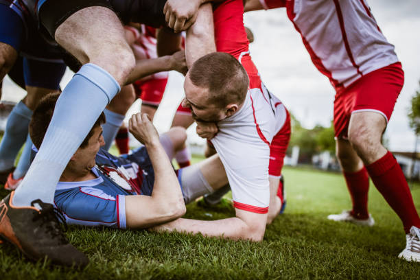 istock Aggressive athletes fighting during a sports match on playing field. 1160746816