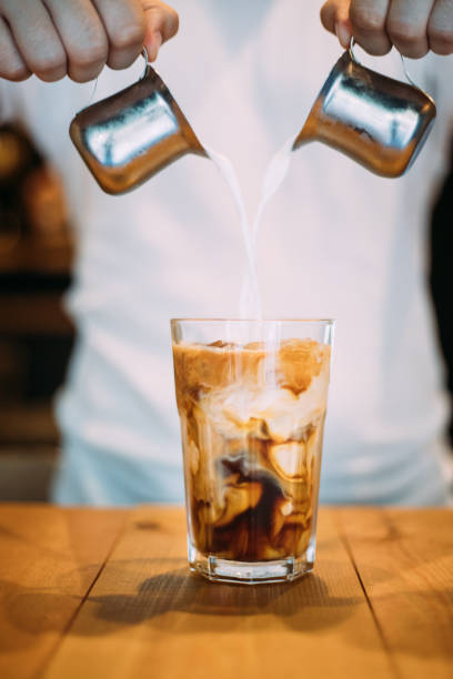 istock Pouring milk in espresso to make iced latte 1160746967
