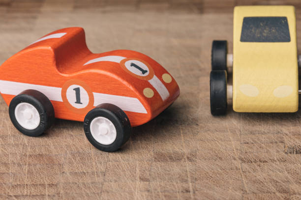 istock Red and yellow toy car on a wooden surface 1160746984