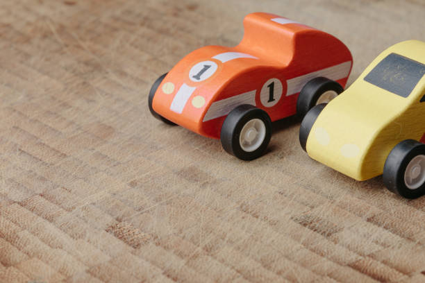 istock Red and yellow toy car on a wooden surface 1160747026