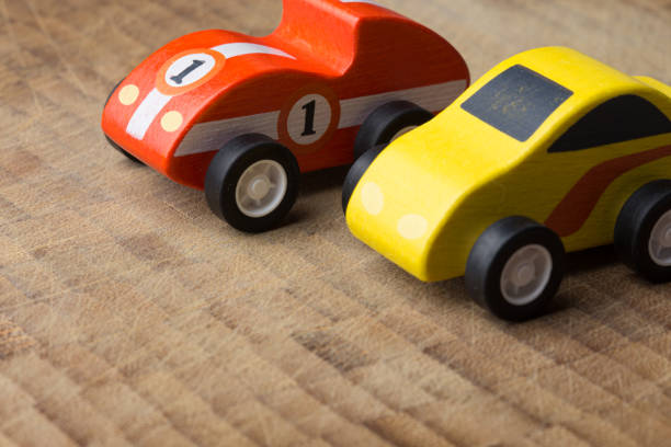 istock Red and yellow toy car on a wooden surface 1160747144