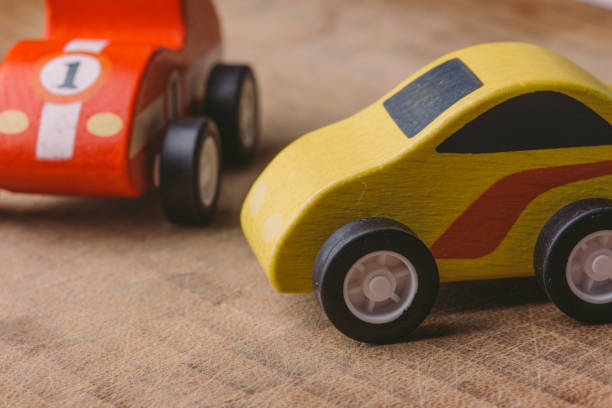 istock Red and yellow toy car on a wooden surface 1160747175