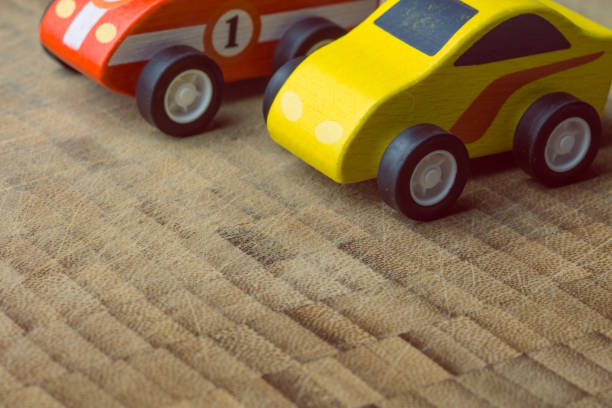 istock Red and yellow toy car on a wooden surface 1160747250