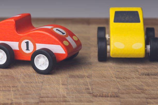 istock Red and yellow toy car on a wooden surface 1160747366