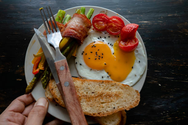 istock homemade healthy breakfast: toast, fried egg, bacon roll 1160747675