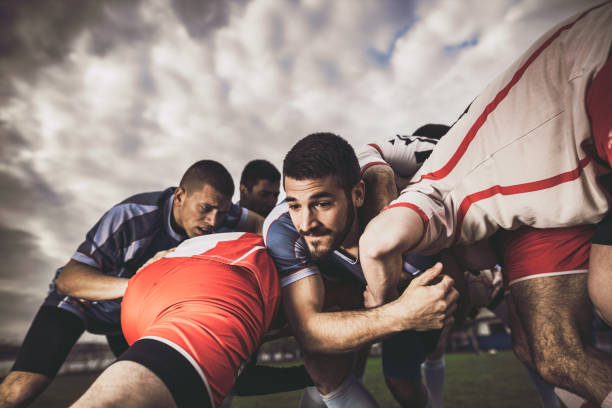 istock Young rugby player trying to get through his rivals on a match. 1160748477