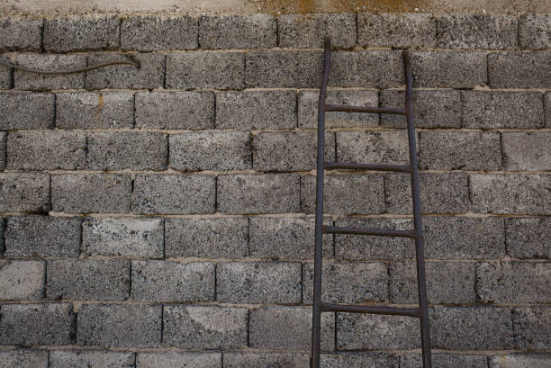 istock Old Brick Wall and Metal Ladders 1160748790