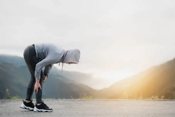 Female runner suffering with pain on sports running injury.