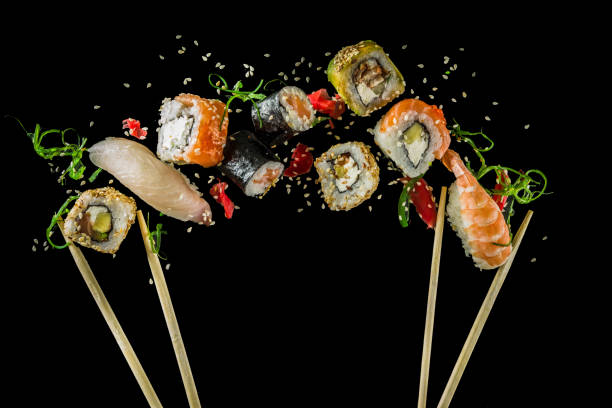 Seamless pattern with sushi Seamless pattern with sushi. Food abstract background. Flying sushi, sashimi and rolls isolated on the black background. japanese food photos stock pictures, royalty-free photos & images