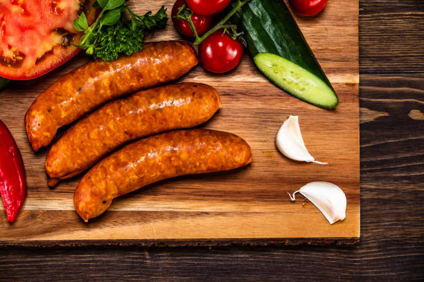 istock Raw sausages on cutting board 1160750153