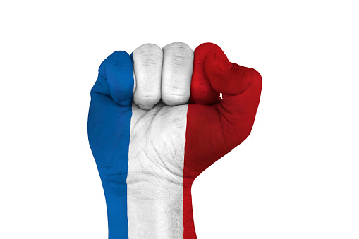 male hand in fist shape with flag covered