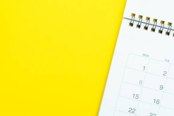 istock Flat lay of white clean desktop calendar on solid yellow background using as reminder, memo, meeting or project and work schedule concept 1160751920