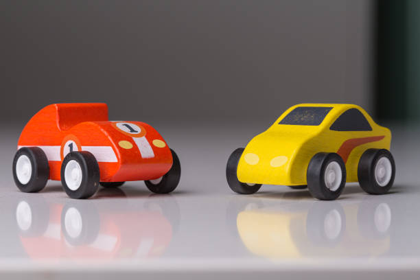 istock Vintage toy cars in a row on a white surface reflection 1160752309