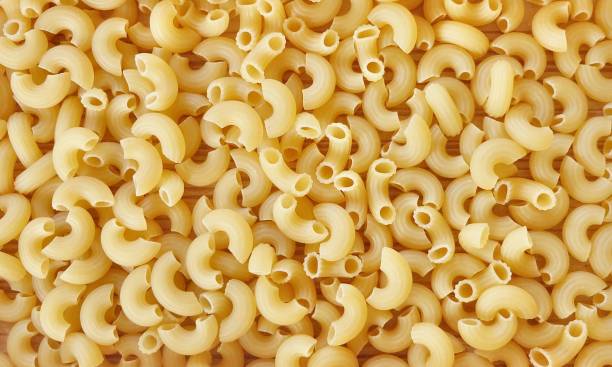 istock Background Textured of Uncooked or Dried Elbow Macaroni 1160753970