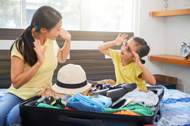 istock Family packing clothes in suitcase 1160754642