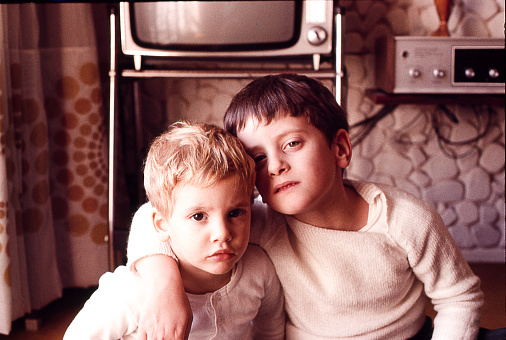 Vintage photo of brothers at home in the seventies.