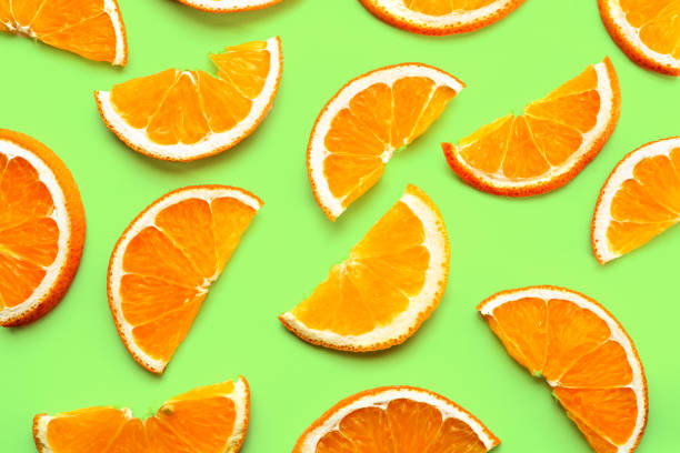 istock Fruit pattern of fresh orange slices on green background. 1160755109