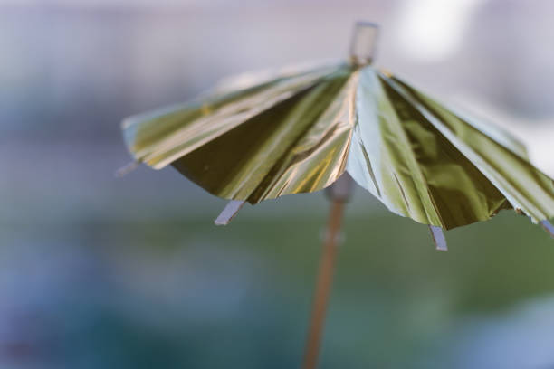 mały parasol na koktajl. rozmyte tło. - drink umbrella umbrella pink paper zdjęcia i obrazy z banku zdjęć