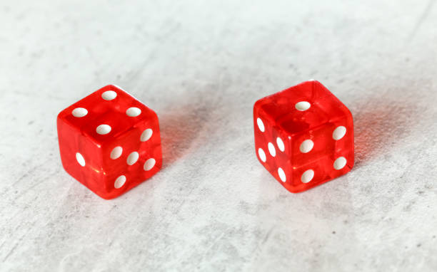istock Two translucent red craps dices on white board showing Fever Five number four and one 1160756385