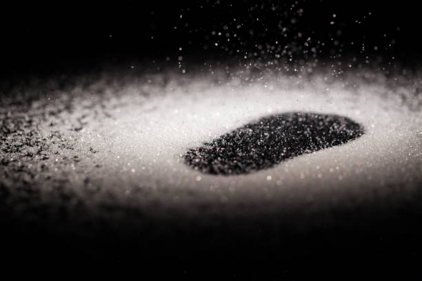 istock Crystals of sugar cover black glass table 1160762641