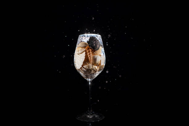 istock Water falls in wineglass full of shells 1160762706