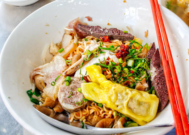 Khmer street food Bowl of yellow noodles soup in Toul Tom Pong street in phnom Penh, Cambodia cambodia food stock pictures, royalty-free photos & images