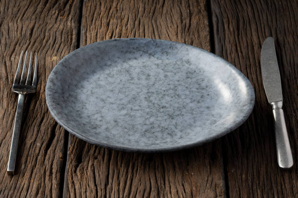 istock plate fork spoon on wood background clear and without depth of field 1160764368