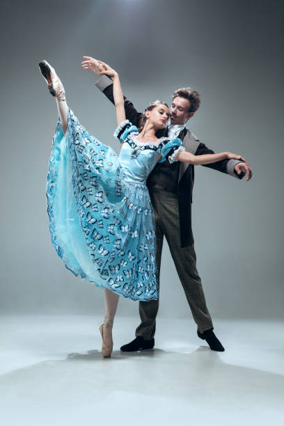 istock Contemporary ballroom dancers on grey studio background 1160766811