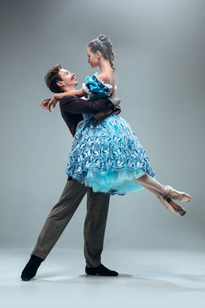 istock Contemporary ballroom dancers on grey studio background 1160766870