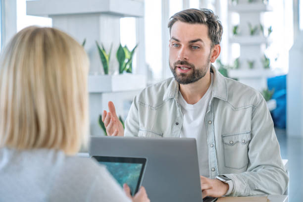 istock Business partners sitting at a coffee table with laptop and digital tablet 1160769962
