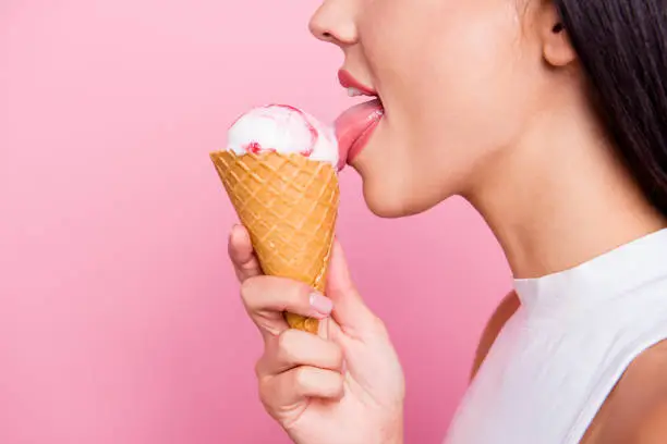 Close-up profile side view portrait of her she nice-looking lovely attractive, cheerful cheery glad lady licking favorite ice cream berry taste flavor isolated over pink pastel background