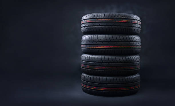 istock New tires pile on a dark background. Copy space. 1160774104