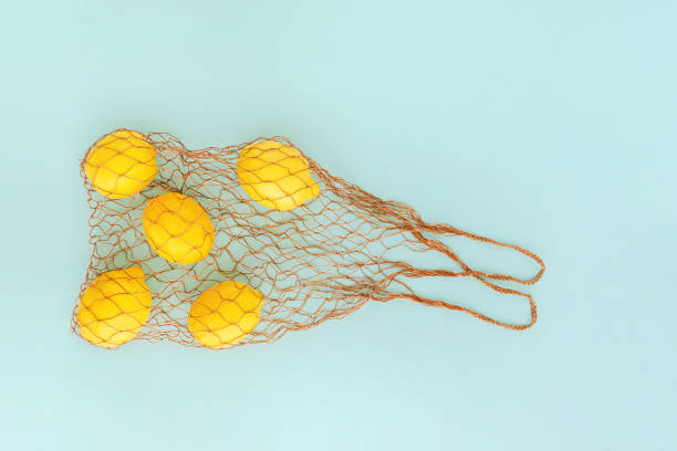 istock Reusable bag with lemons on blue background. Zero waste and plastic free shopping concept. 1160774809